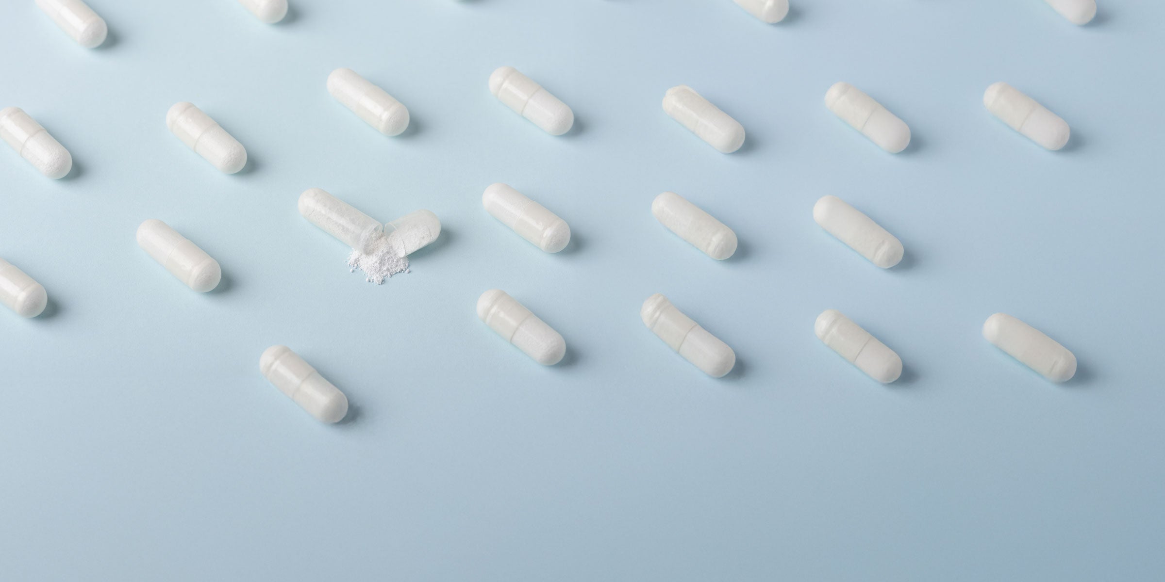 white capsules organized on blue background