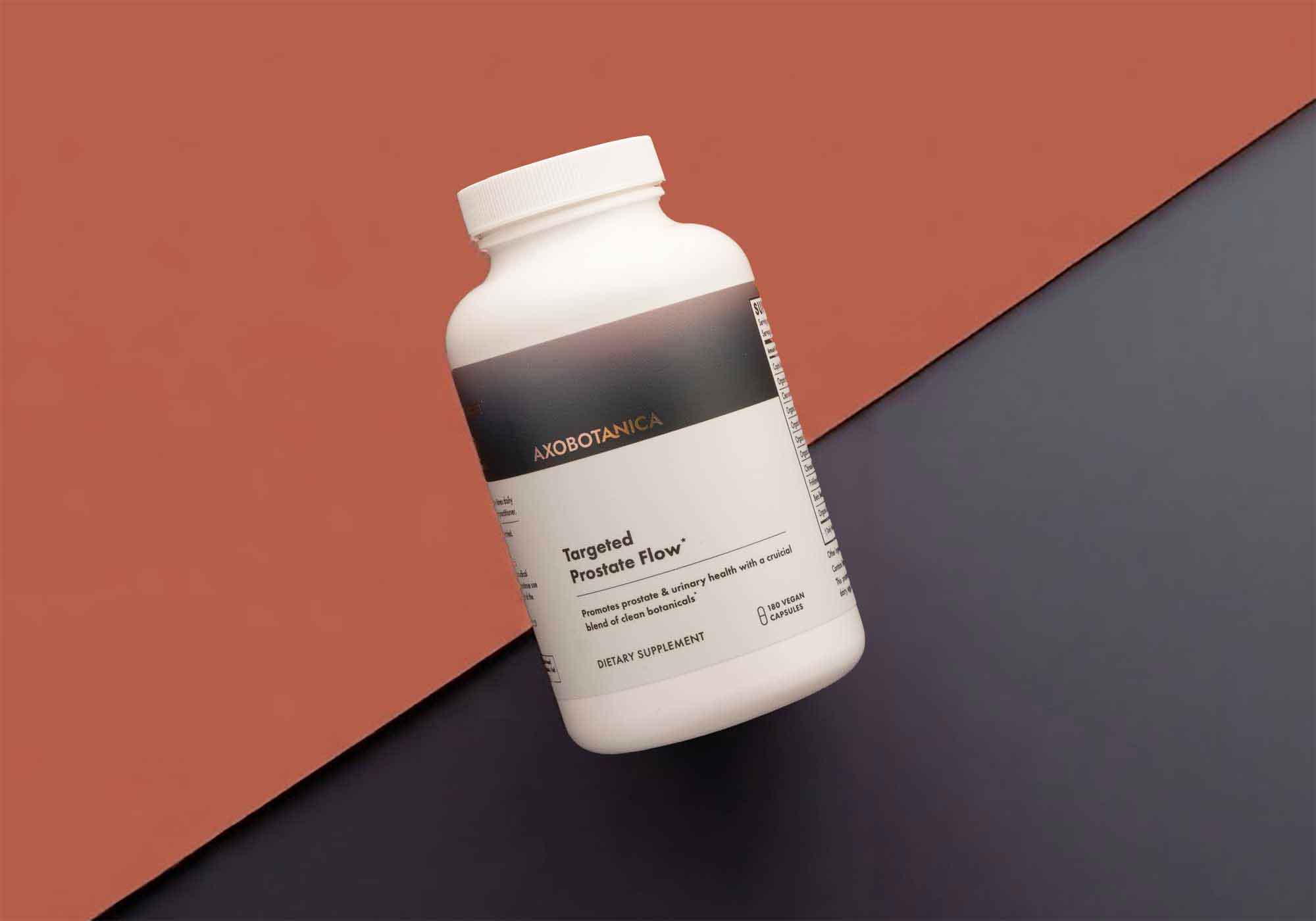 White supplement bottle with black label on a two-tone brown and gray background