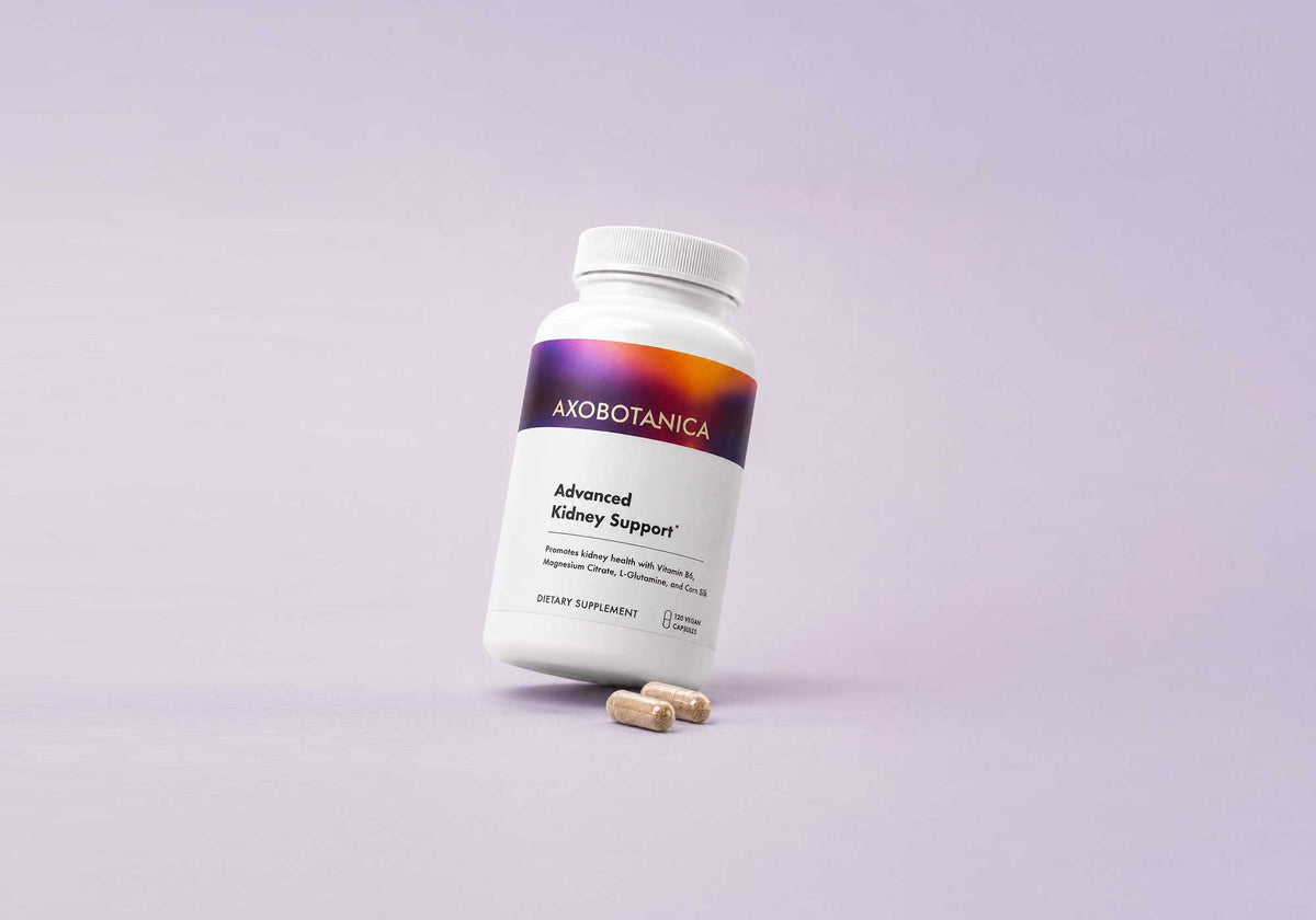 White bottle of Advanced Kidney Support dietary supplement with two beige capsules in front