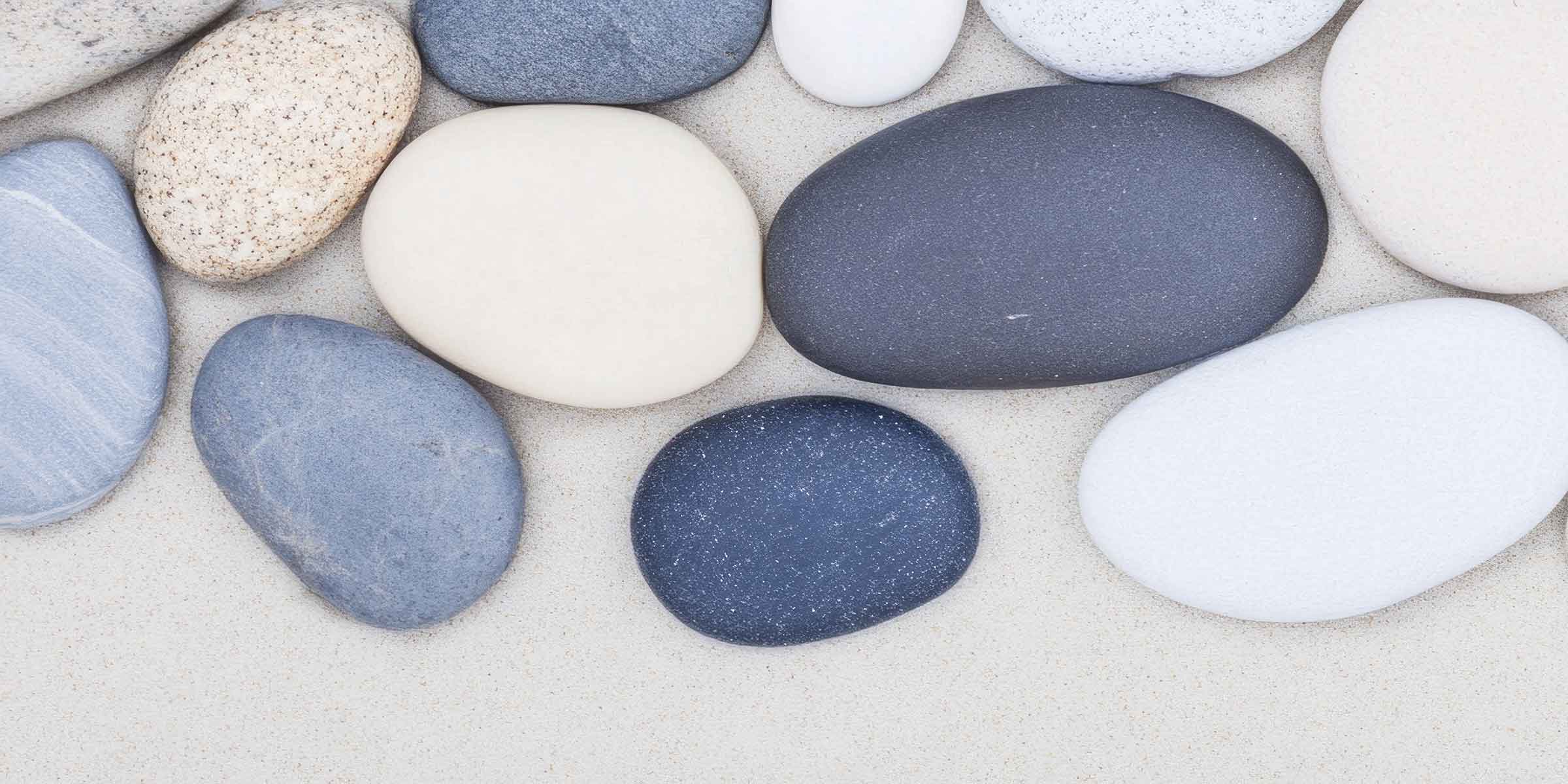 Smooth, rounded pebbles on a sandy beach