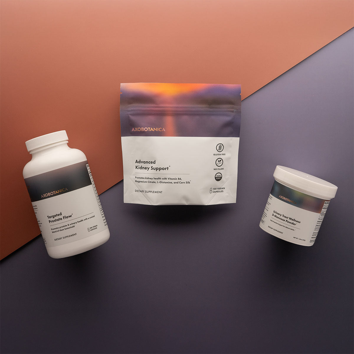 Three Axobotanica health supplement products on a two-tone background