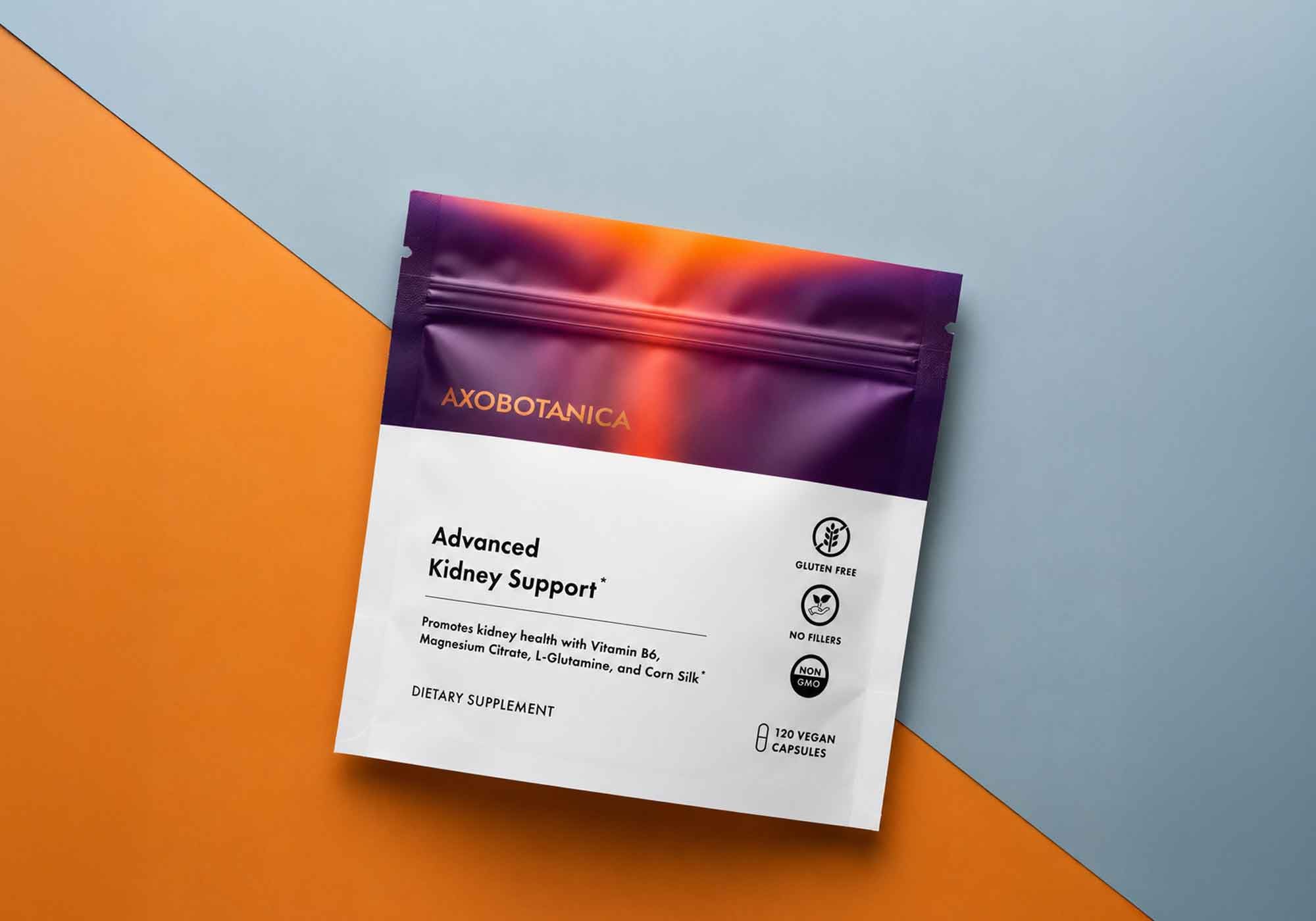 A stand-up pouch of Axobotanica Advanced Kidney Support dietary supplement, placed diagonally on a split orange and light blue background.