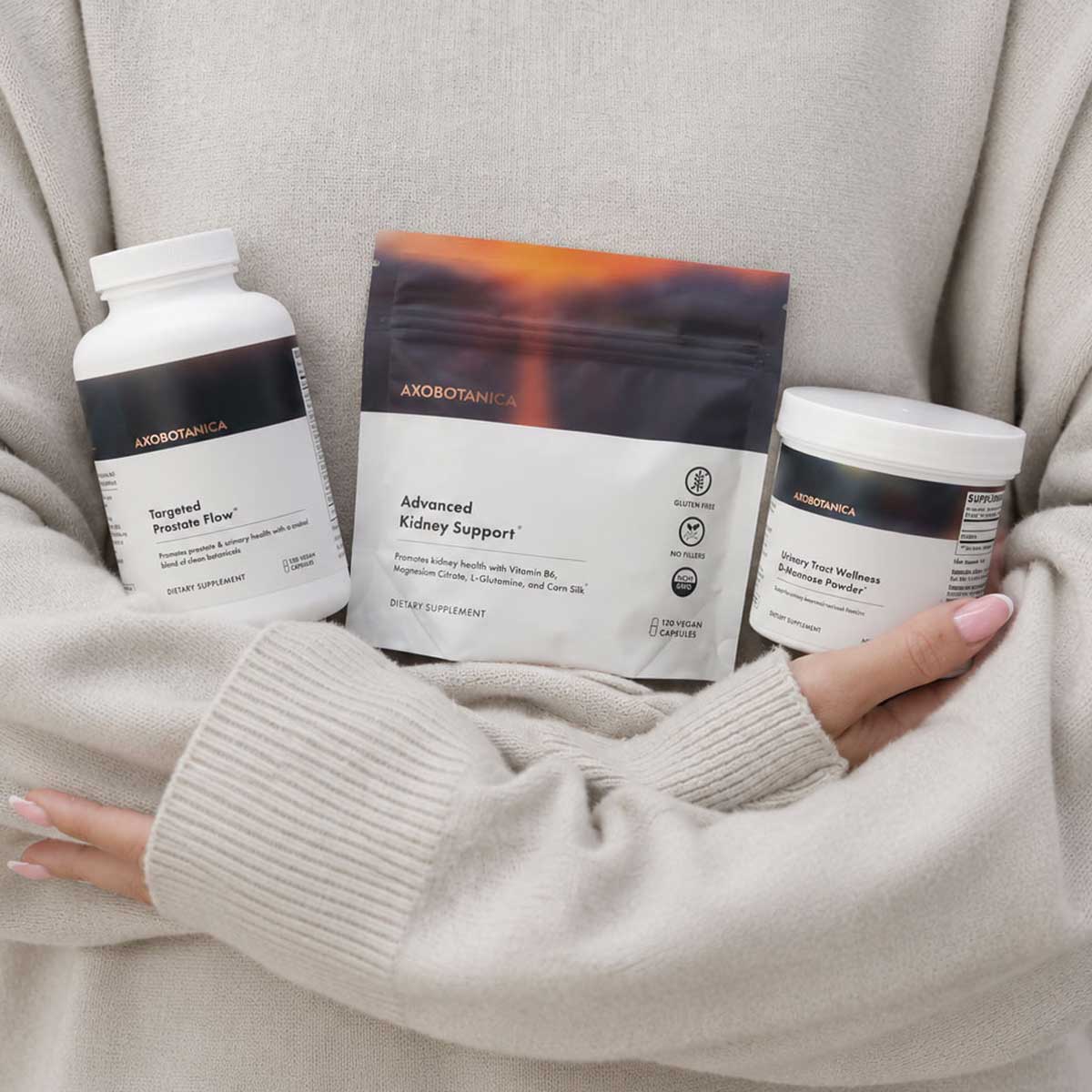 Woman holding three Axobotanica products