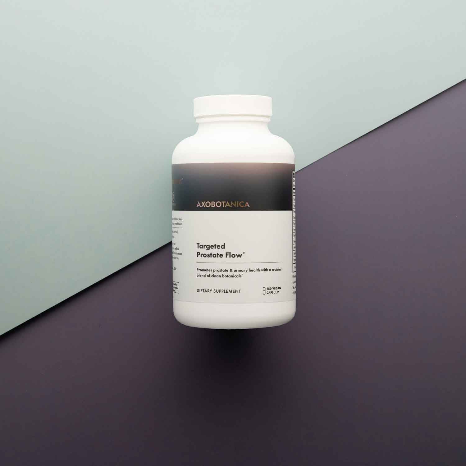 White supplement bottle labeled 'Axobotanica' on a two-tone background
